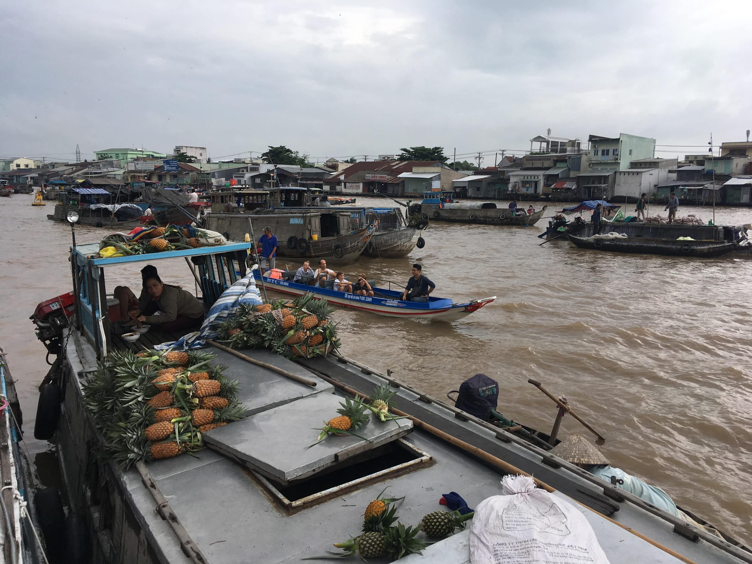 A boat piled with pineapples at the Cai Rang floating market on the Hau River near Can Tho