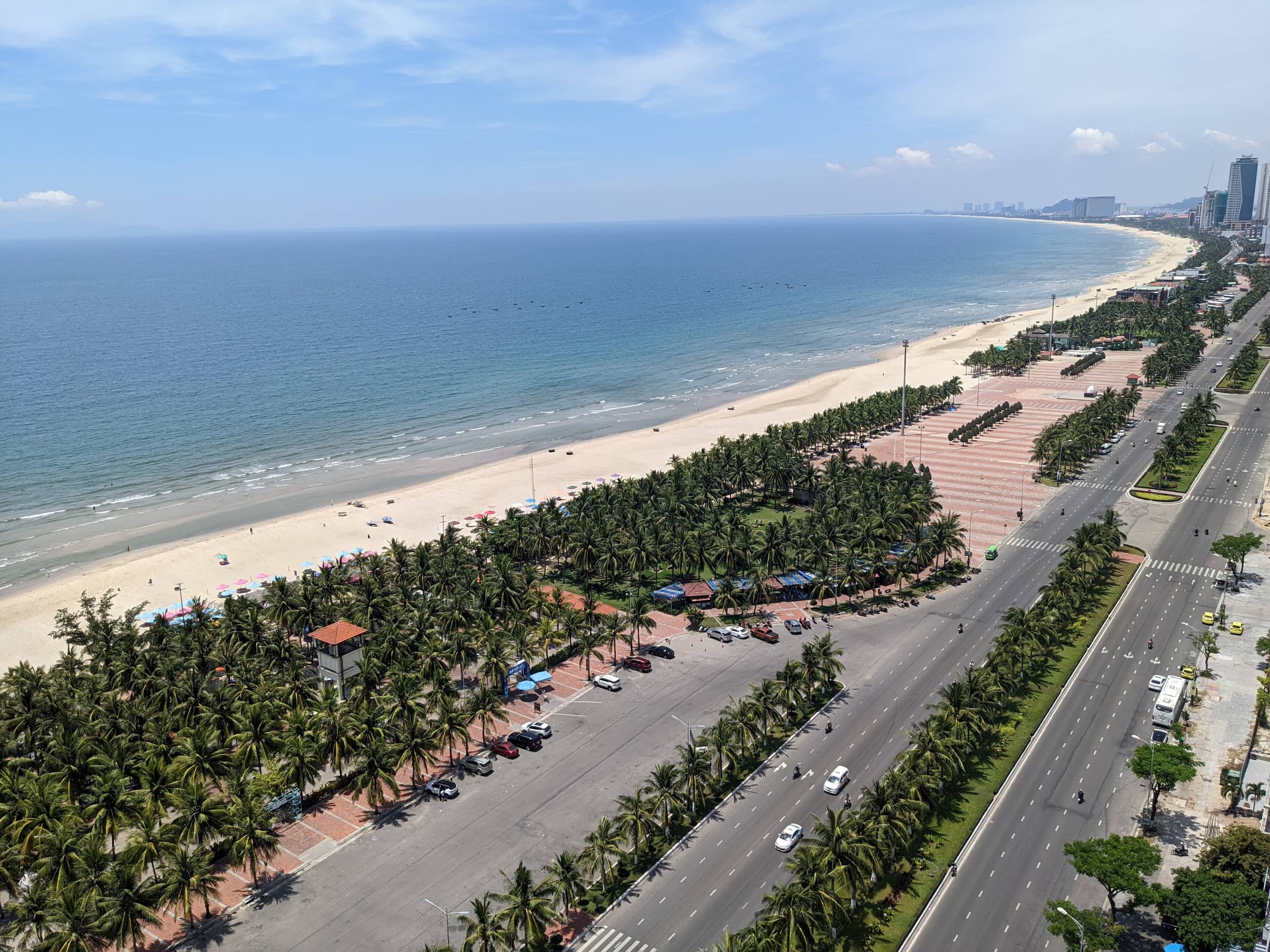 My Khe beach and the coast road with palm trees, looking along the Da Nang shoreline