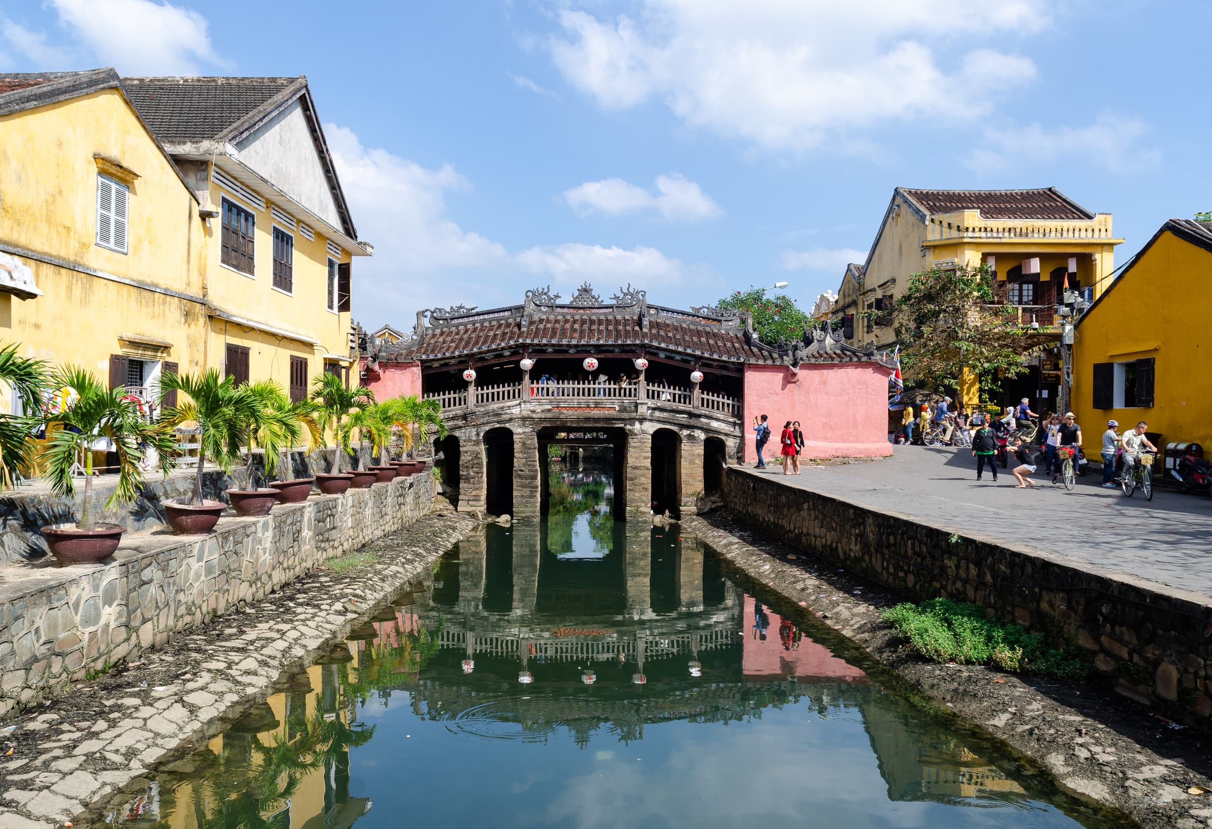 The Japanese Covered Bridge and yellow old town houses in Hoi An