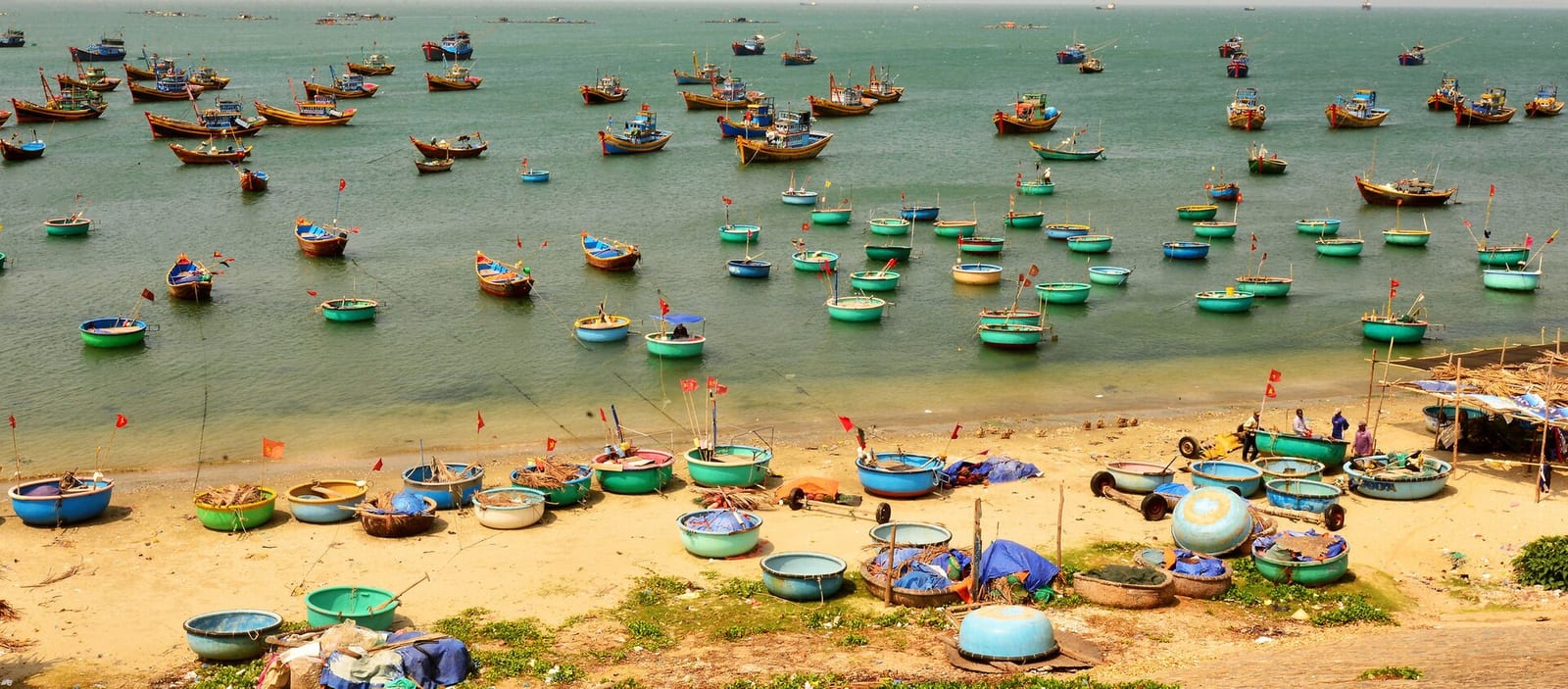 Round coracle fishing boats on the water and sand at Mui Ne fishing village