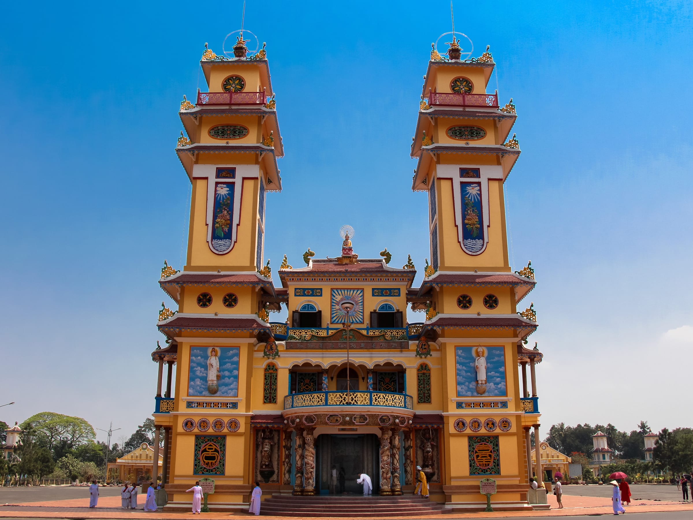 The twin towers and yellow facade of the Cao Dai Holy See at Tay Ninh