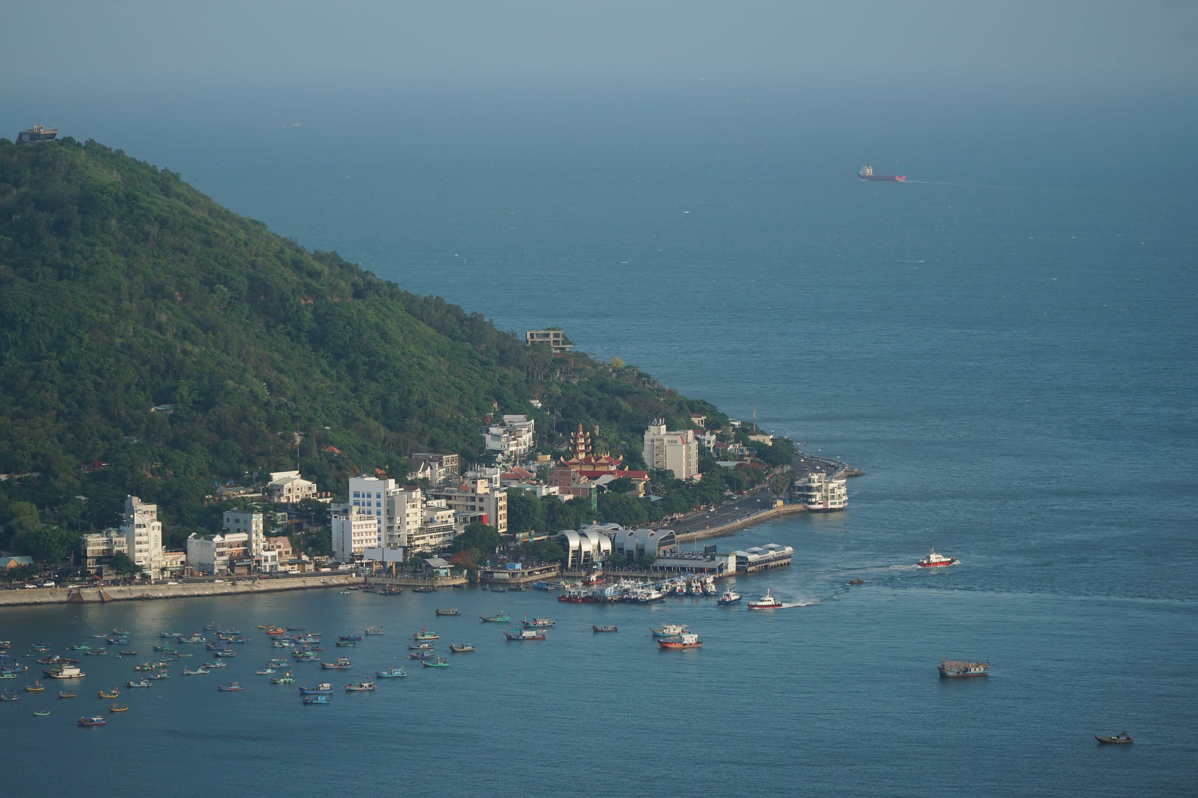 The wooded hill above the Front Beach waterfront and harbour at Vung Tau, with boats in the bay